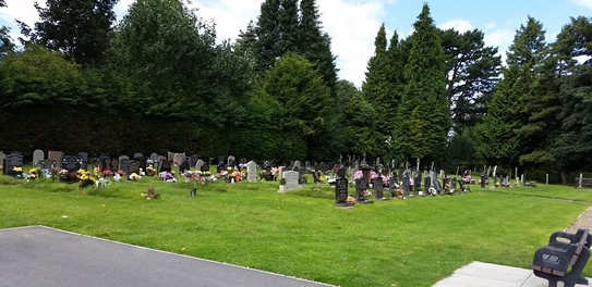 Bedale Burial Ground, with gravestones and green grass.